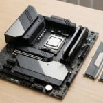 Placa base moderna sobre una mesa de trabajo, con procesador instalado en el socket, disipadores de VRM visibles y módulos de memoria DDR5 colocados al lado.