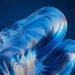 Estructura de vidrio translúcido con formas ondulantes en tonos azules y blancos sobre fondo azul oscuro.
