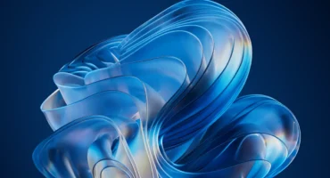 Estructura de vidrio translúcido con formas ondulantes en tonos azules y blancos sobre fondo azul oscuro.