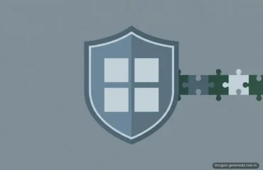 289-microsoft-parches-seguridad-patch-tuesday-septiembre-filtracion Escudo azul gris con ventana de cuatro cristales blancos, atravesado por piezas de puzle verde y blanco. Imagen generada con IA.