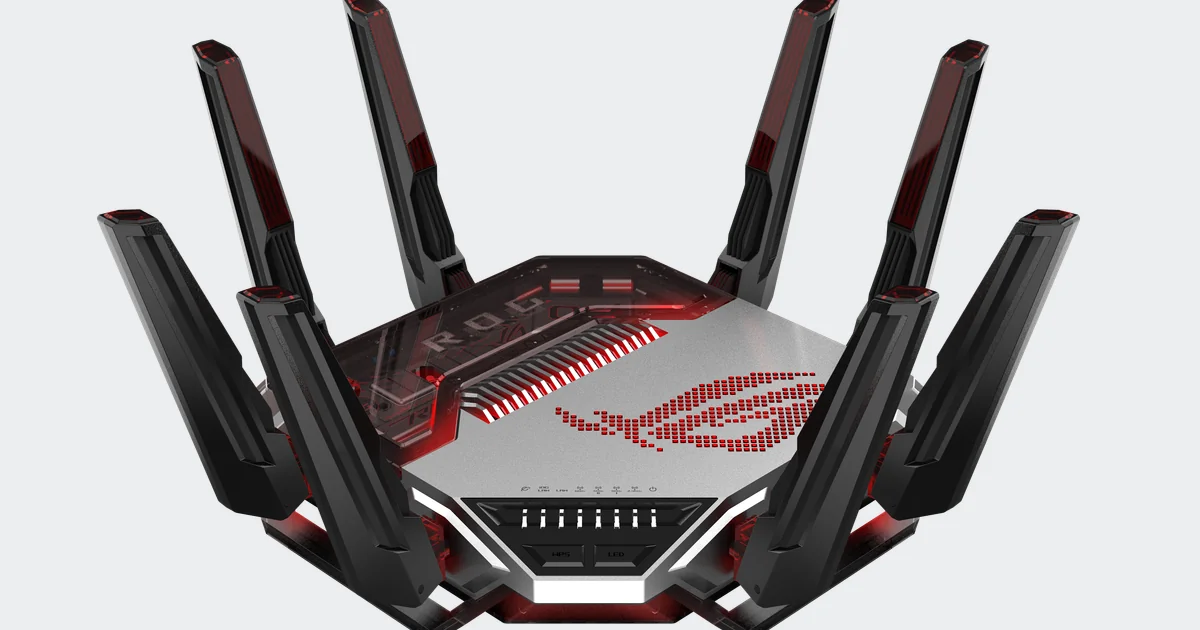 asus-rog-rapture-gt-bn98 Router ASUS ROG Rapture GT-BN98 negro y plateado con sus antenas desplegadas y el logotipo de ROG iluminado en rojo, sobre fondo gris claro