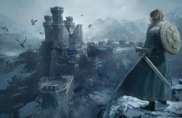 dragons-dogma-2-dark-arisen-norgan Imagen oficial de Dragon’s Dogma 2: Dark Arisen con un personaje de espaldas, con espada y escudo, ante una fortaleza en ruinas entre montañas nevadas