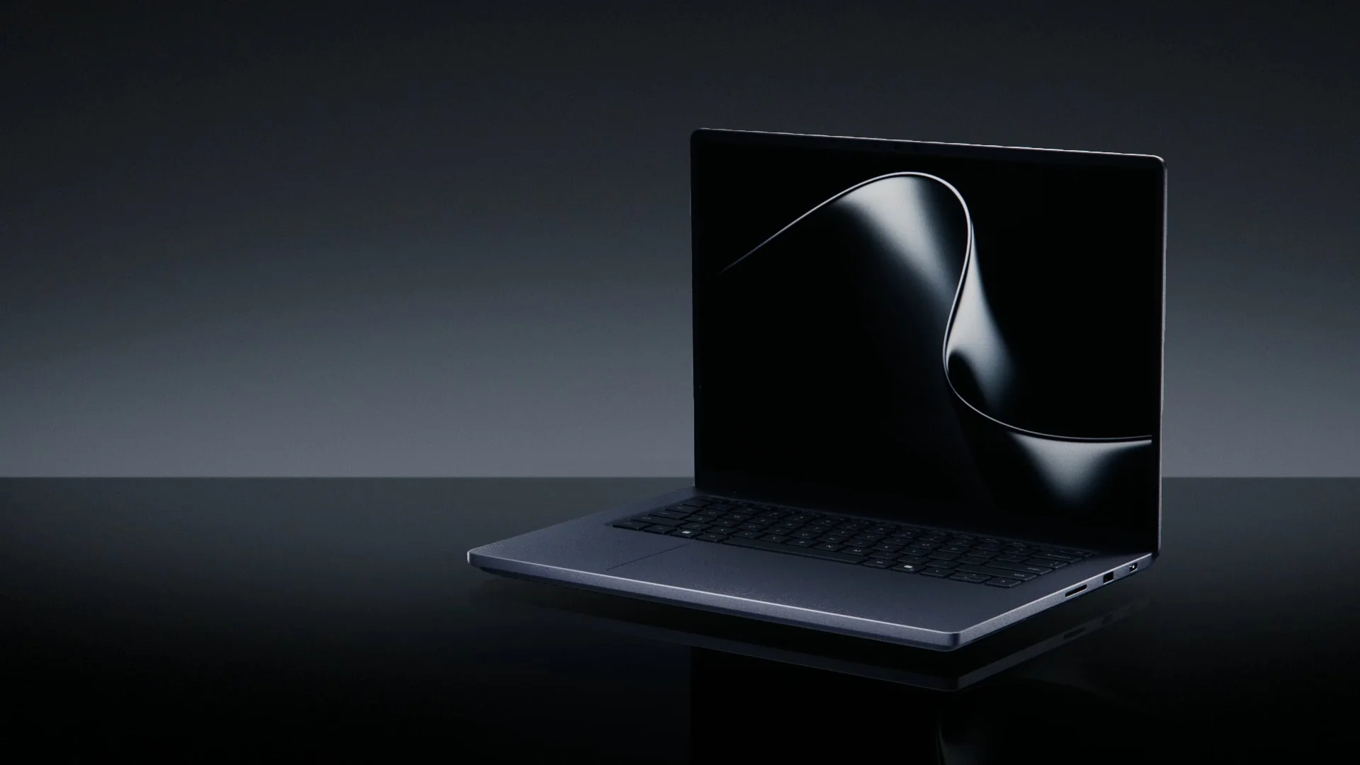 surface-laptop-ultra-atenuacion-local Portátil Surface Laptop Ultra abierto sobre una superficie negra brillante, con la pantalla encendida